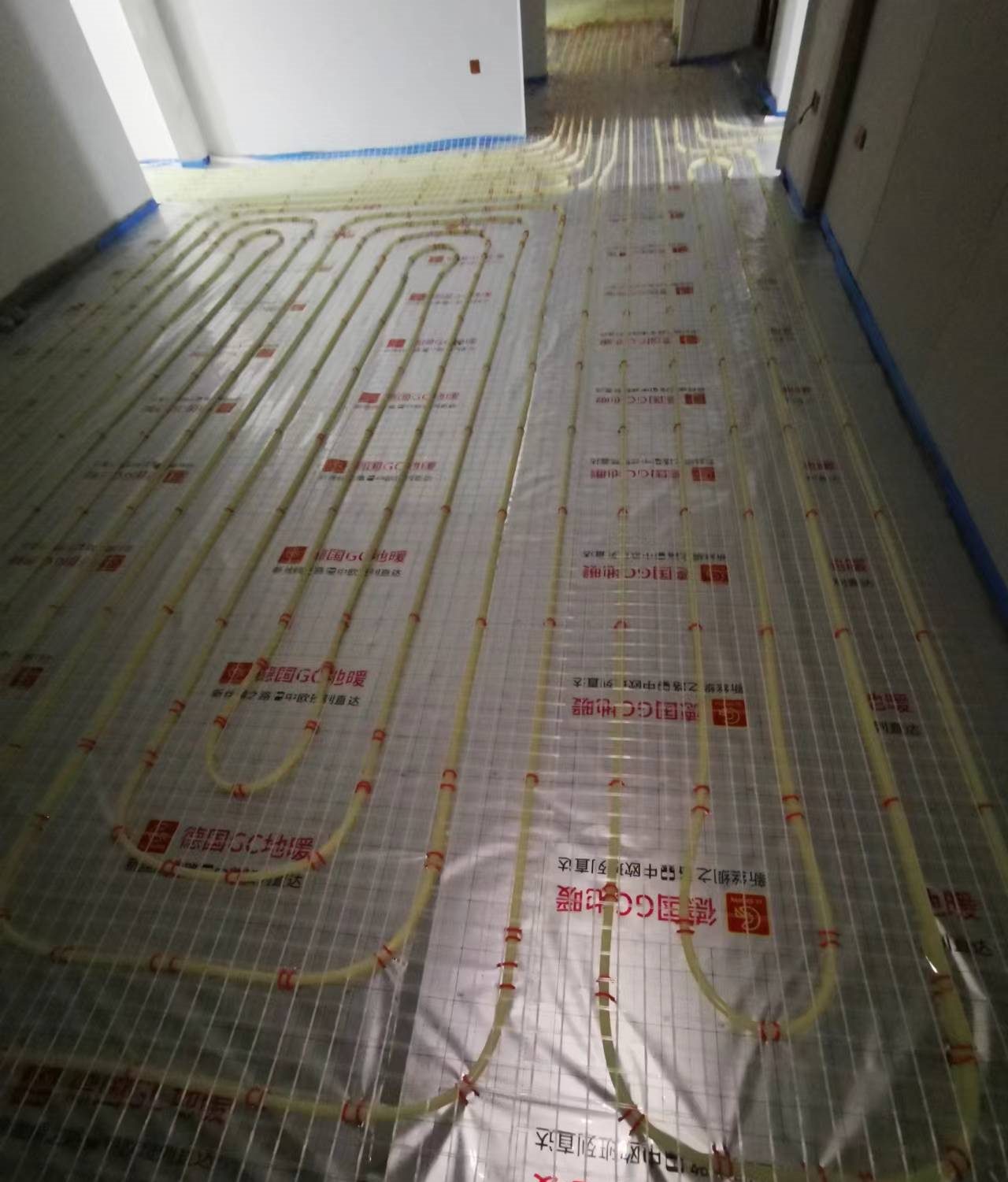 地板采暖系统安装施工现场实拍：反射膜与钢丝网铺装，边界保温条到位